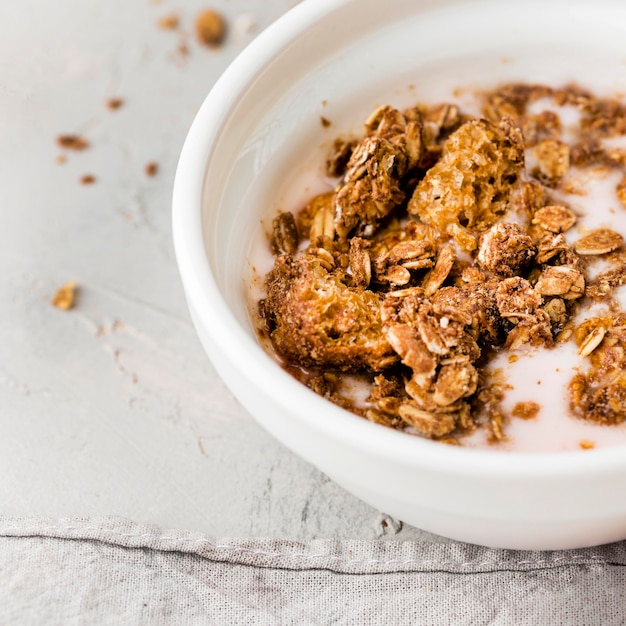 Close-up breakfast bowl with granola and milk