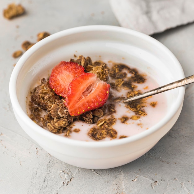 Close-up breakfast bowl with granola and strawberry