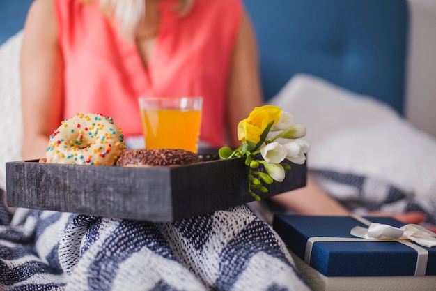 Close-up of breakfast tray next to a gift