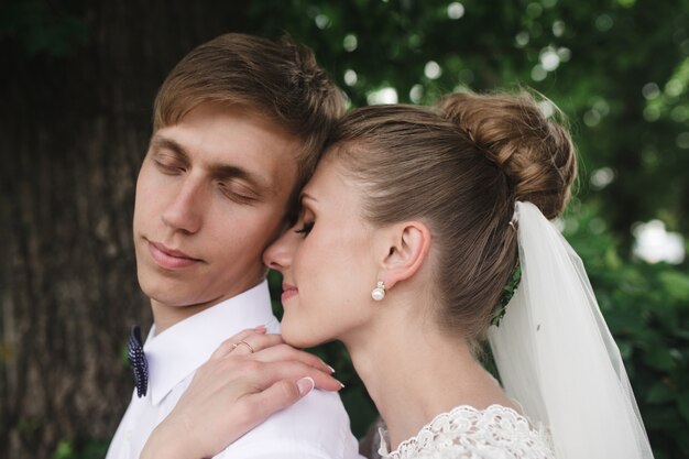 Close-up of bride hugging her husband