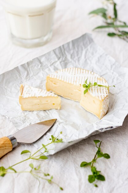 Close-up brie cheese and glass of milk