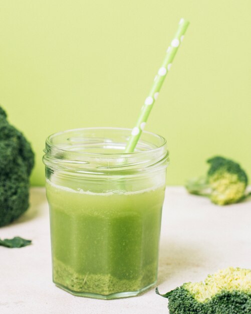 Close up broccoli smoothie with green straw