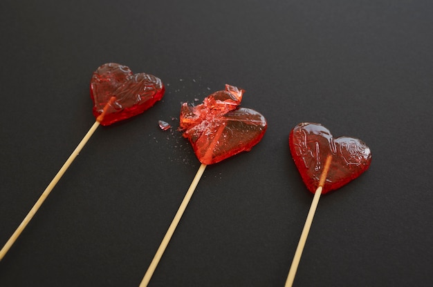 Close-up of broken heart candy treat on stick