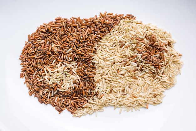 Close up of brown and white grains mixed in a white plate creating  ying and yang