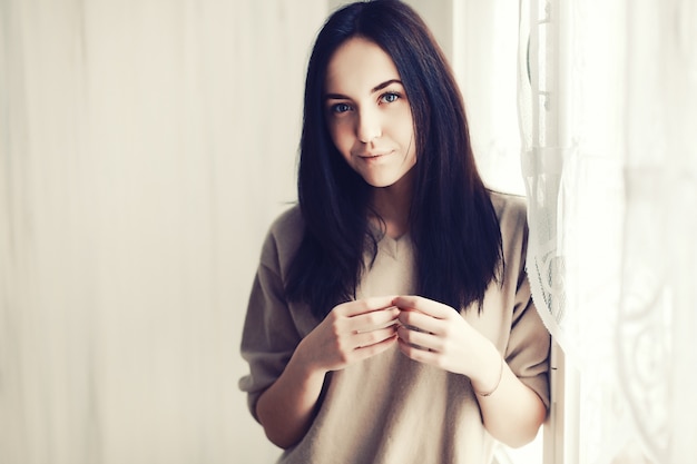 Close-up of brunette girl wearing a brown pullover