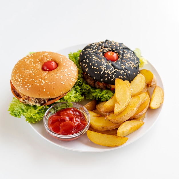 Close-up burgers with fries on plate