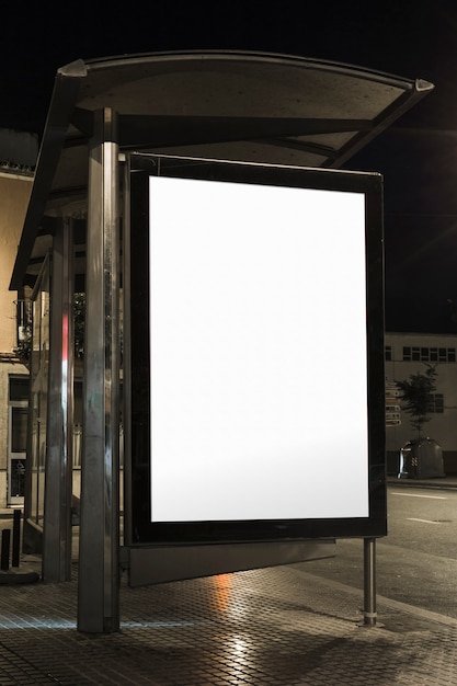 Close-up of bus shelter billboard at night