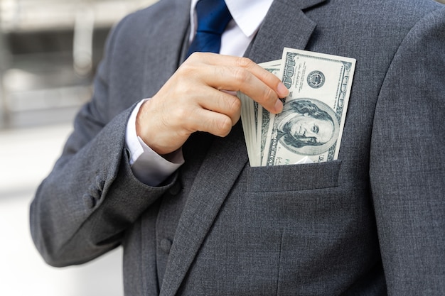 Close up business man holding money US dollar bills in hand