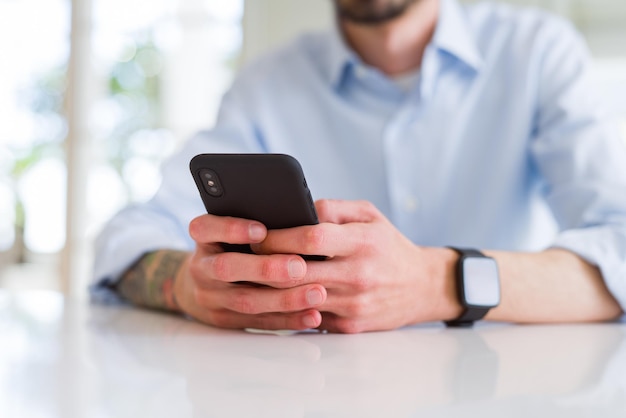 Free photo close up of business man working using smartphone