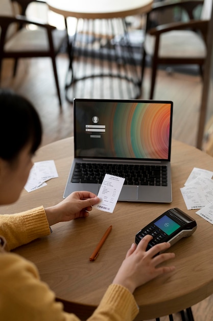 close up business owner holding receipt