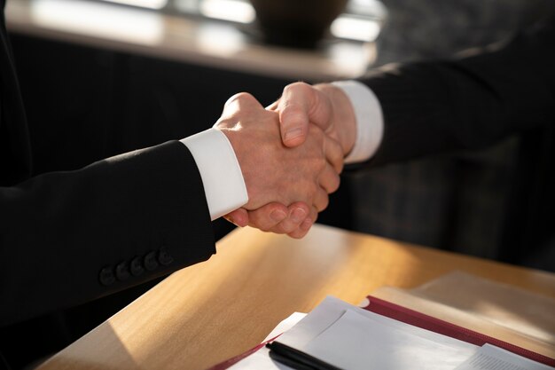 Close up business people shaking hands