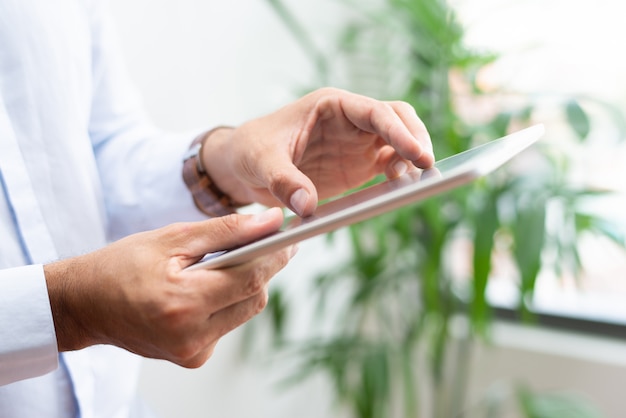 Close-up of businessman analyzing chart on tablet