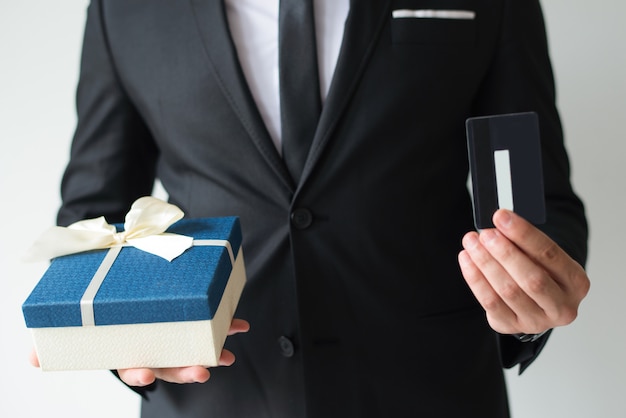Close-up of businessman buying Christmas gift using credit card