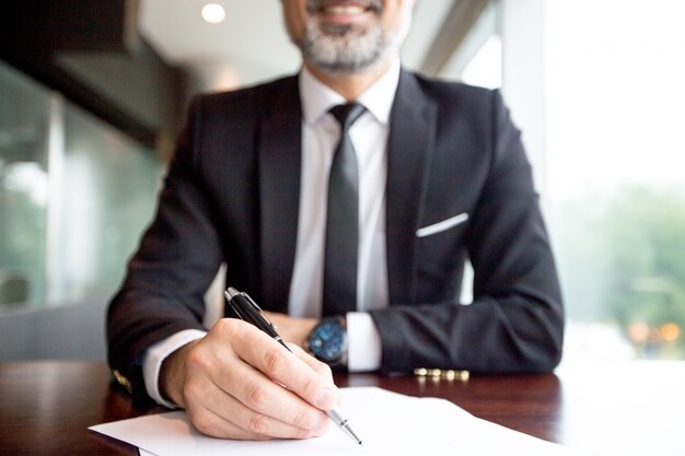 Close-up of businessman doing paperwork