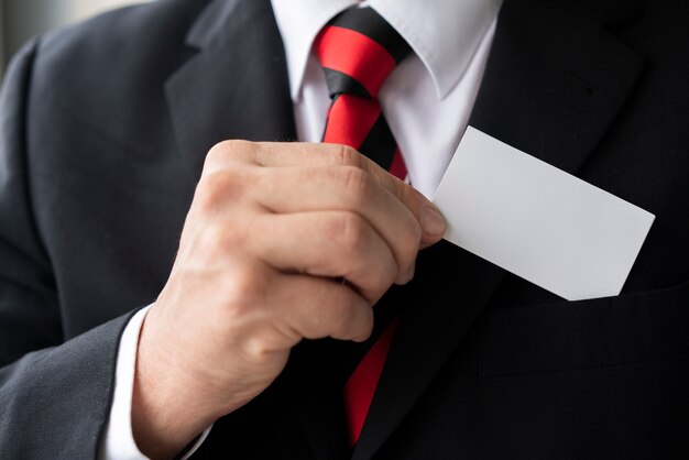 Close-up businessman holding a card