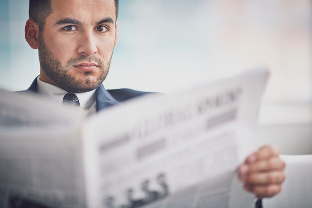 Close-up of businessman holding a newspaper