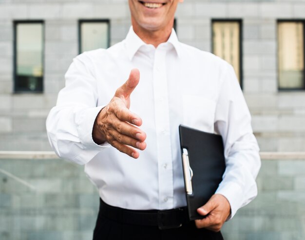 Close-up businessman holding out hand