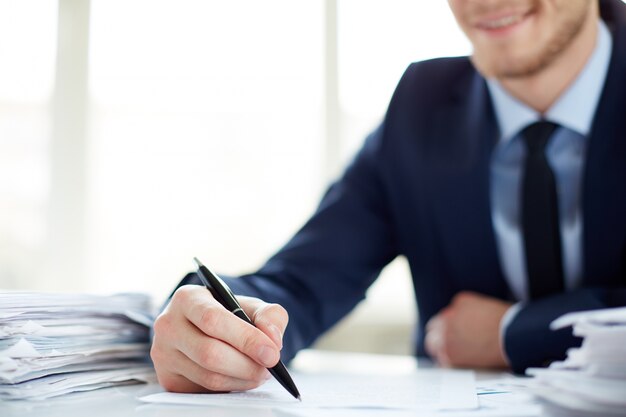 Close-up of businessman holding a pen