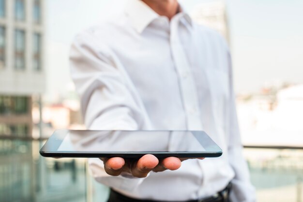 Close-up businessman holding tablet