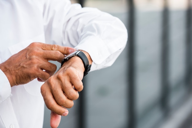 Close-up businessman looking at wrist watch