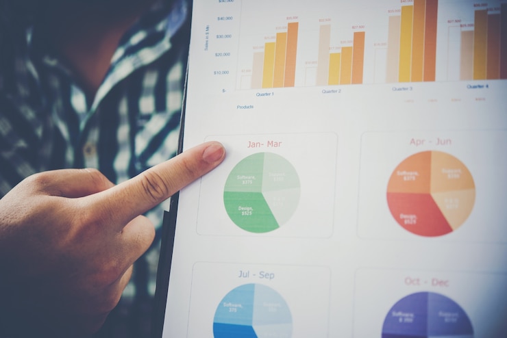 Free Photo close up of businessman in a meeting or presentation hand pointing with business chart document on the table.