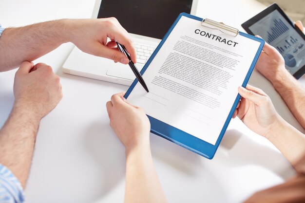 Close-up of businessman pointing where to sign