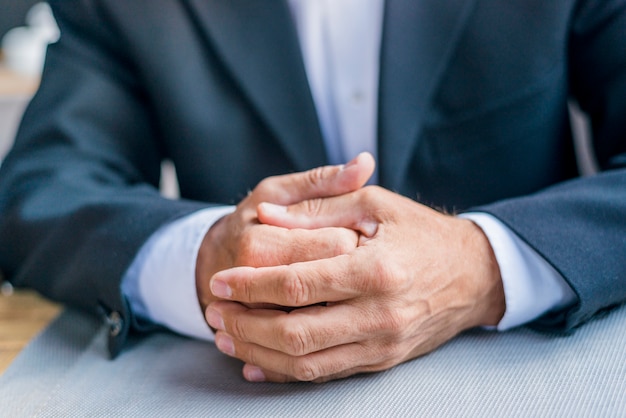 Close-up of a businessman's clasped hand