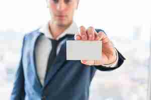Free photo close-up of businessman's hand showing blank business card