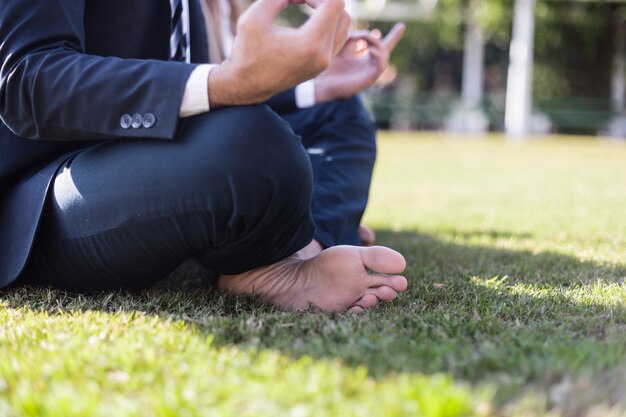 Close-up of businessman sitting cross-legged