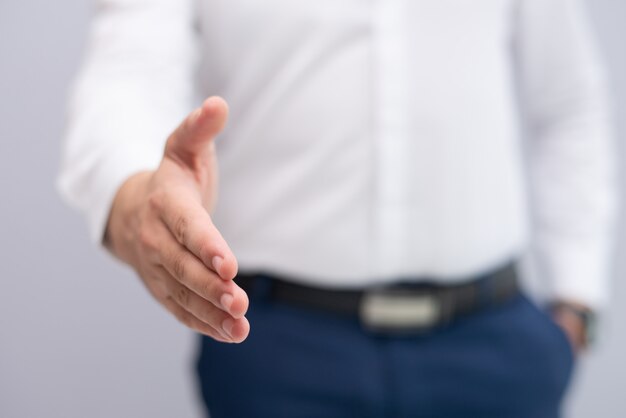 Close-up of businessman stretching hand for handshake