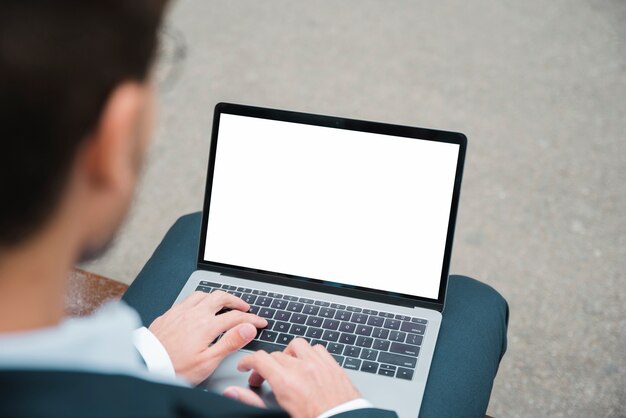 Close-up of businessman typing on laptop