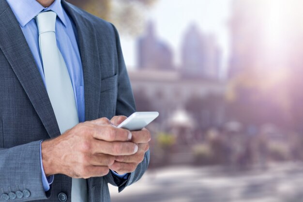 Close-up of businessman using his smartphone