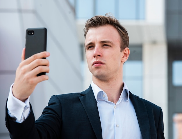 Close-up businessman using phone