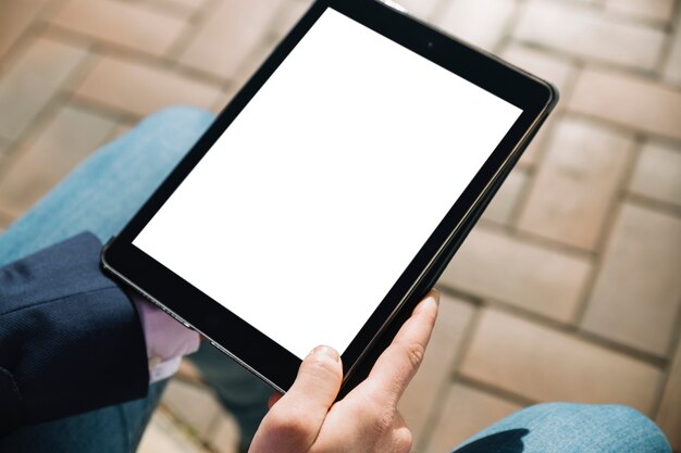 Close up of businessman using tablet outdoors