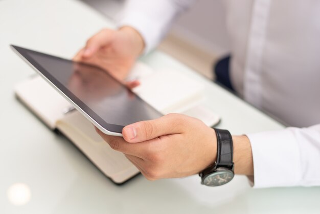 Close-up of businessman watching video on digital tablet