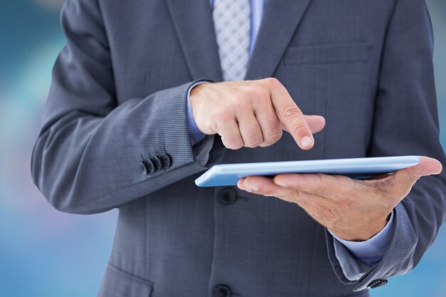 Close-up of businessman working with his tablet