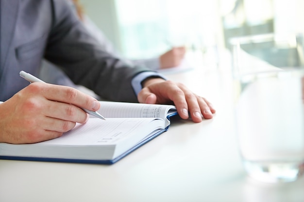 Close-up of businessman writing an idea