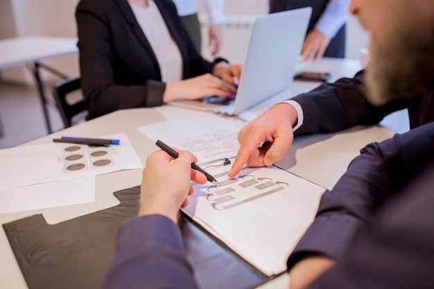 Close-up of businesspeople hands during discussion of business plan