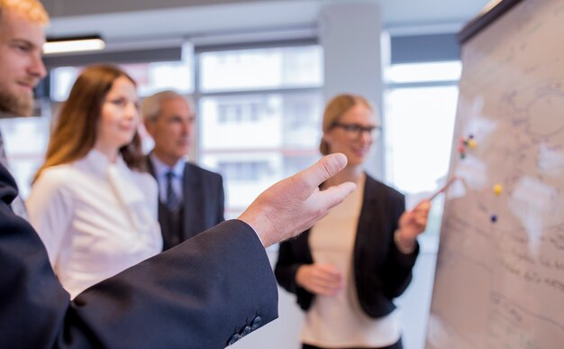 Close-up of businesspeople having discussion with co-workers