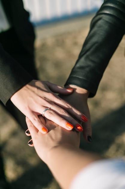 Close-up of businesspeople stacking their hands at outdoors