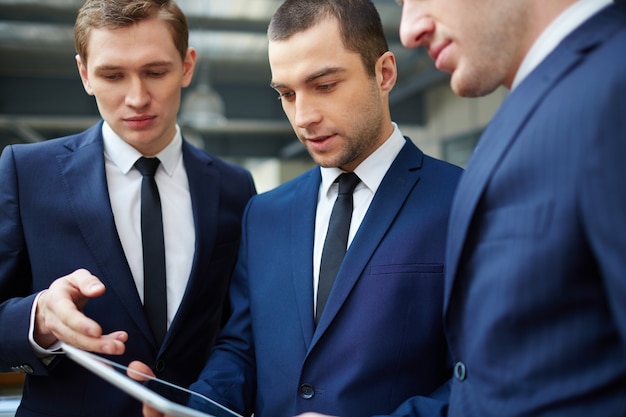 Close-up of businesspeople with digital tablet