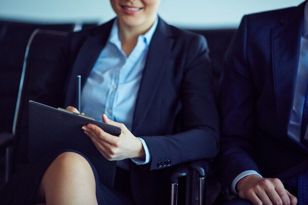 Close-up of businesswoman holding clipboard