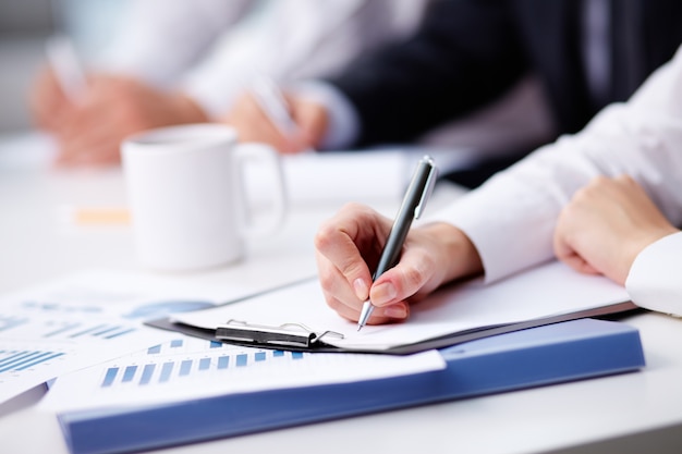 Free photo close-up of busy businesswoman writing