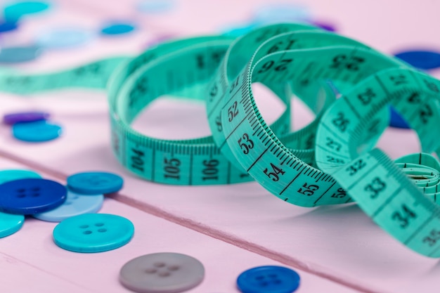 Close-up of buttons and measuring tape