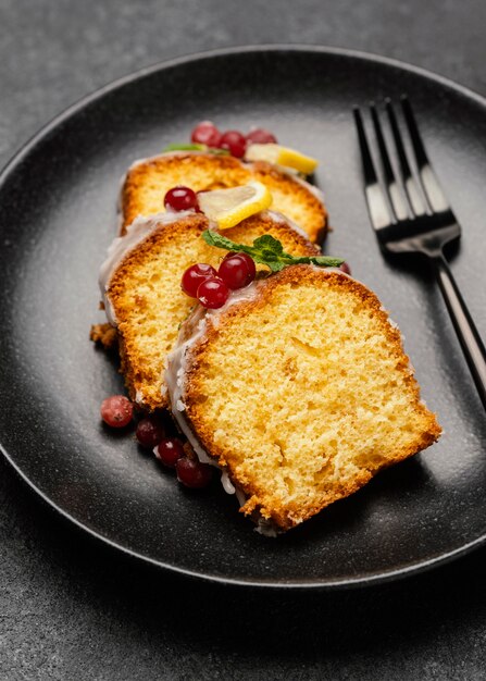 Close-up of cake slices on plate with fork and berries