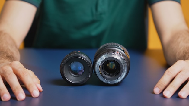 Close up of camera lenses while photographer records vlog. Camera lens technology digital recording social media influencer content creator, professional studio for podcast, vlogging and blogging