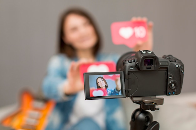 Close-up camera on tripod recording blogger