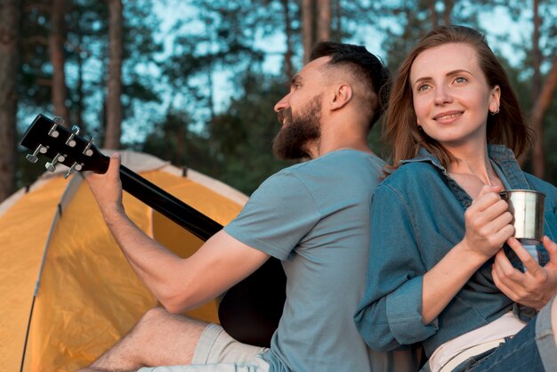 Close up of camping couple back to back