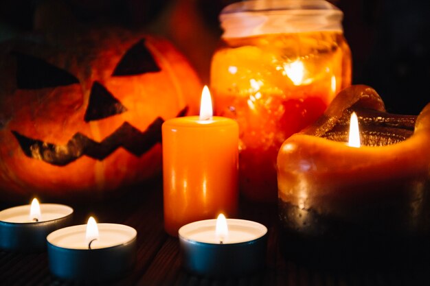 Close-up of candles and Halloween pumpkin