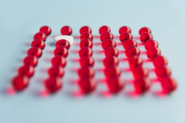 Free photo close up of capsules with one white pill